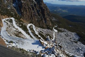 A snowy road winding through switchbacks up into the mountain, jacobs ladder